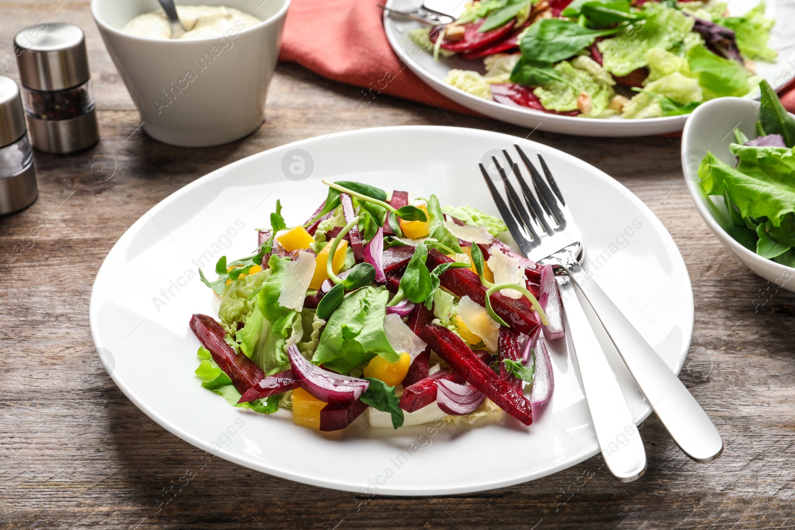 Photo of Plate with delicious beet salad served on table