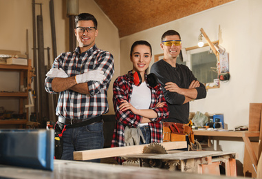 Team of professional carpenters in modern workshop