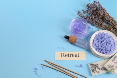 Photo of Retreat concept. Composition with card, dried lavender flowers and different spa products on light blue background, space for text