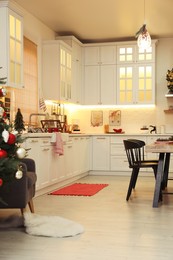 Photo of Cozy dining room decorated for Christmas. Interior design
