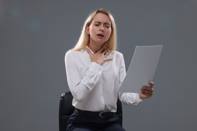 Photo of Casting call. Emotional woman with script performing against grey background