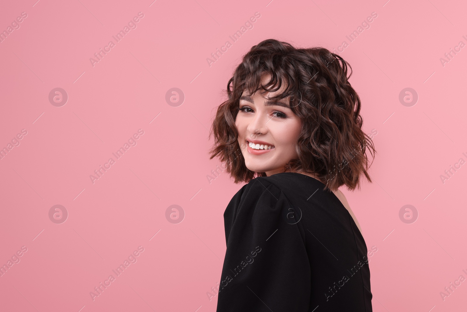 Photo of Portrait of beautiful young woman with wavy hairstyle on pink background. Space for text