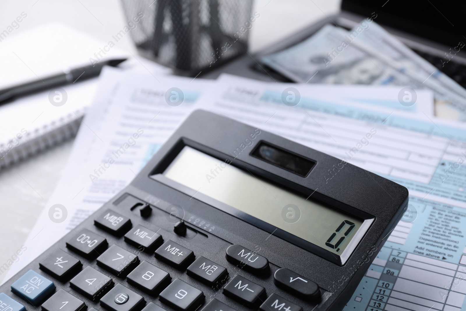 Photo of Tax accounting. Calculator and documents on table, closeup