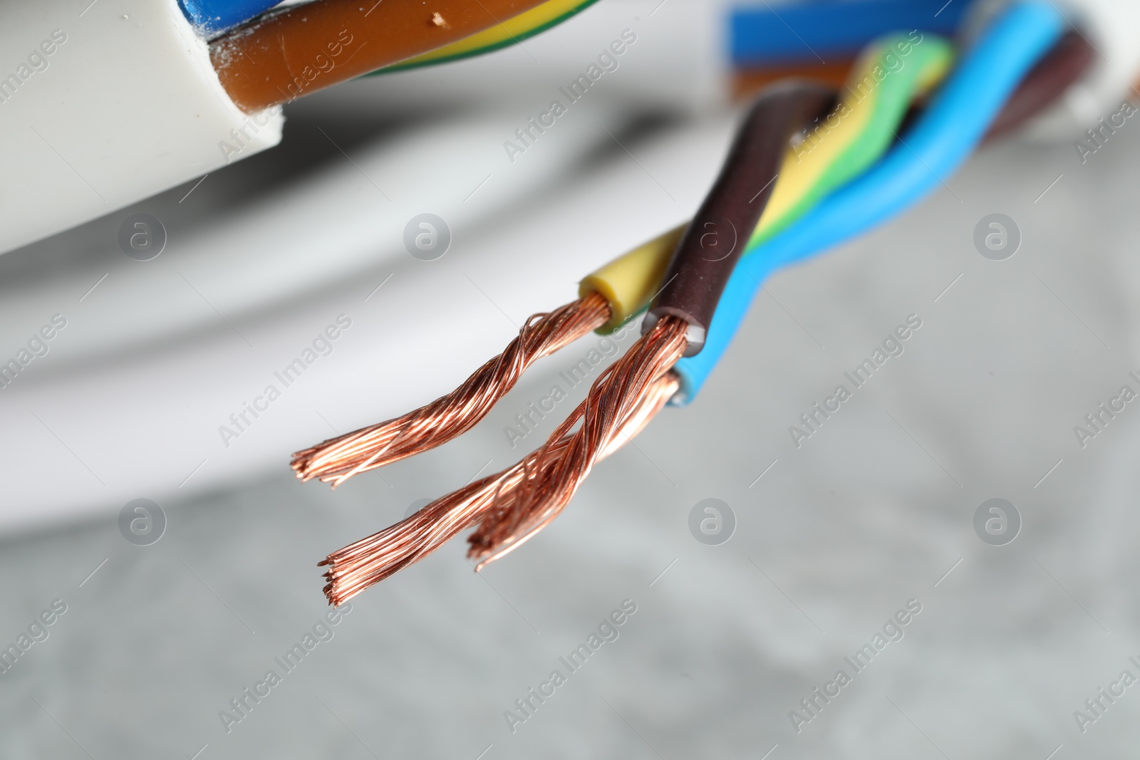 Photo of Colorful electrical wires on blurred background, closeup