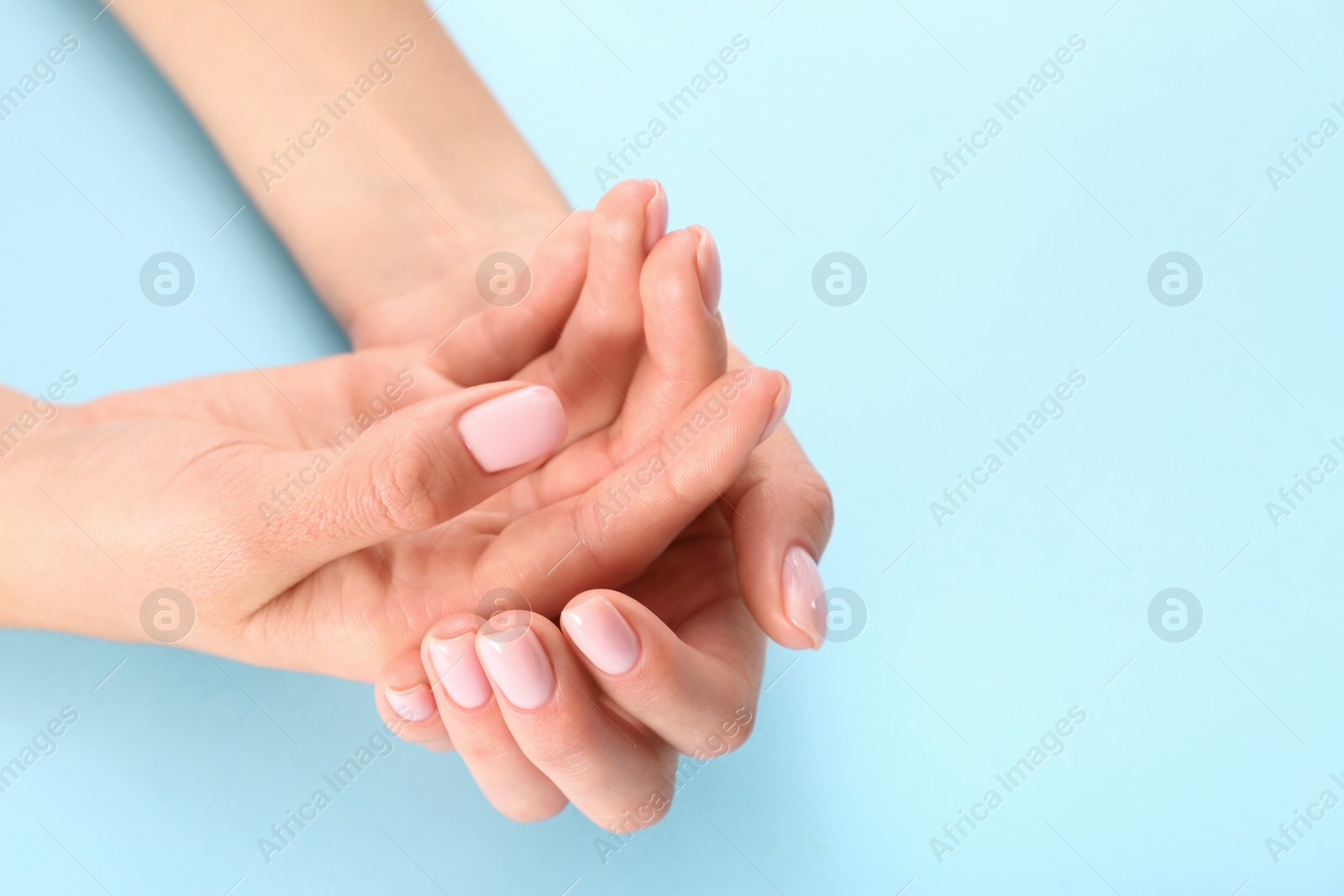 Photo of Closeup view of woman with beautiful hands on color background, space for text. Spa treatment