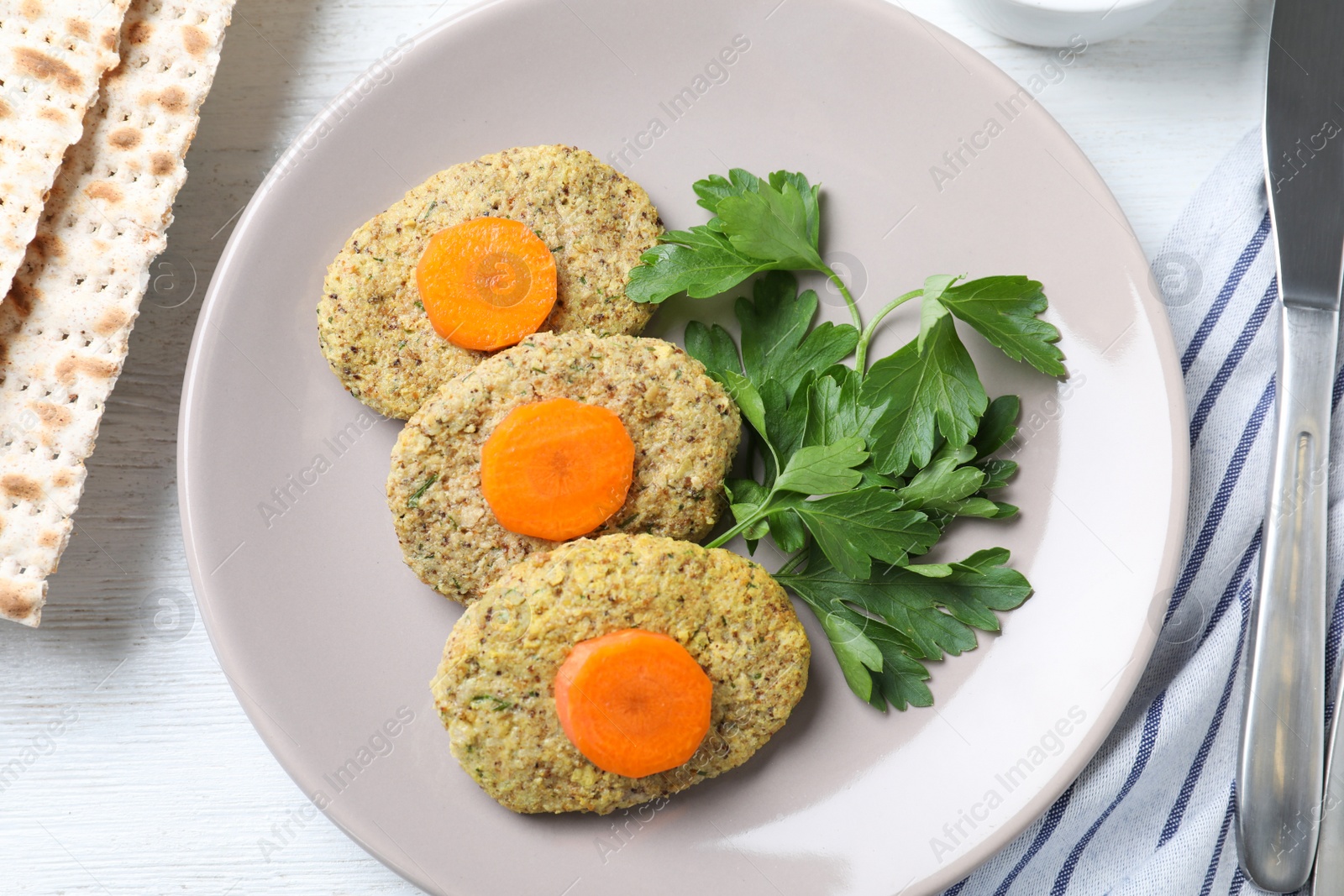 Photo of Plate of traditional Passover (Pesach) gefilte fish on wooden background, top view