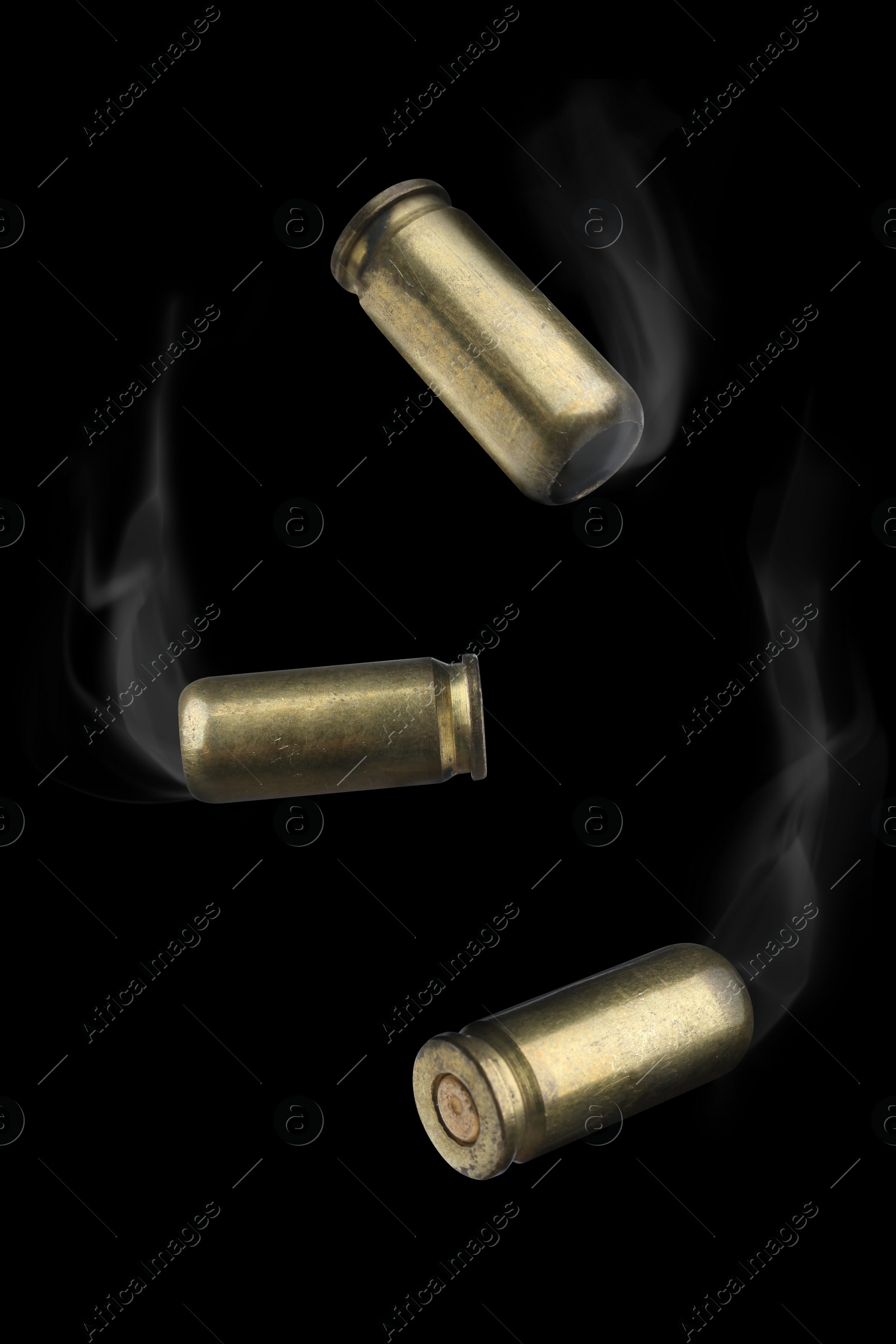 Image of Cartridge cases with smoke falling on black background