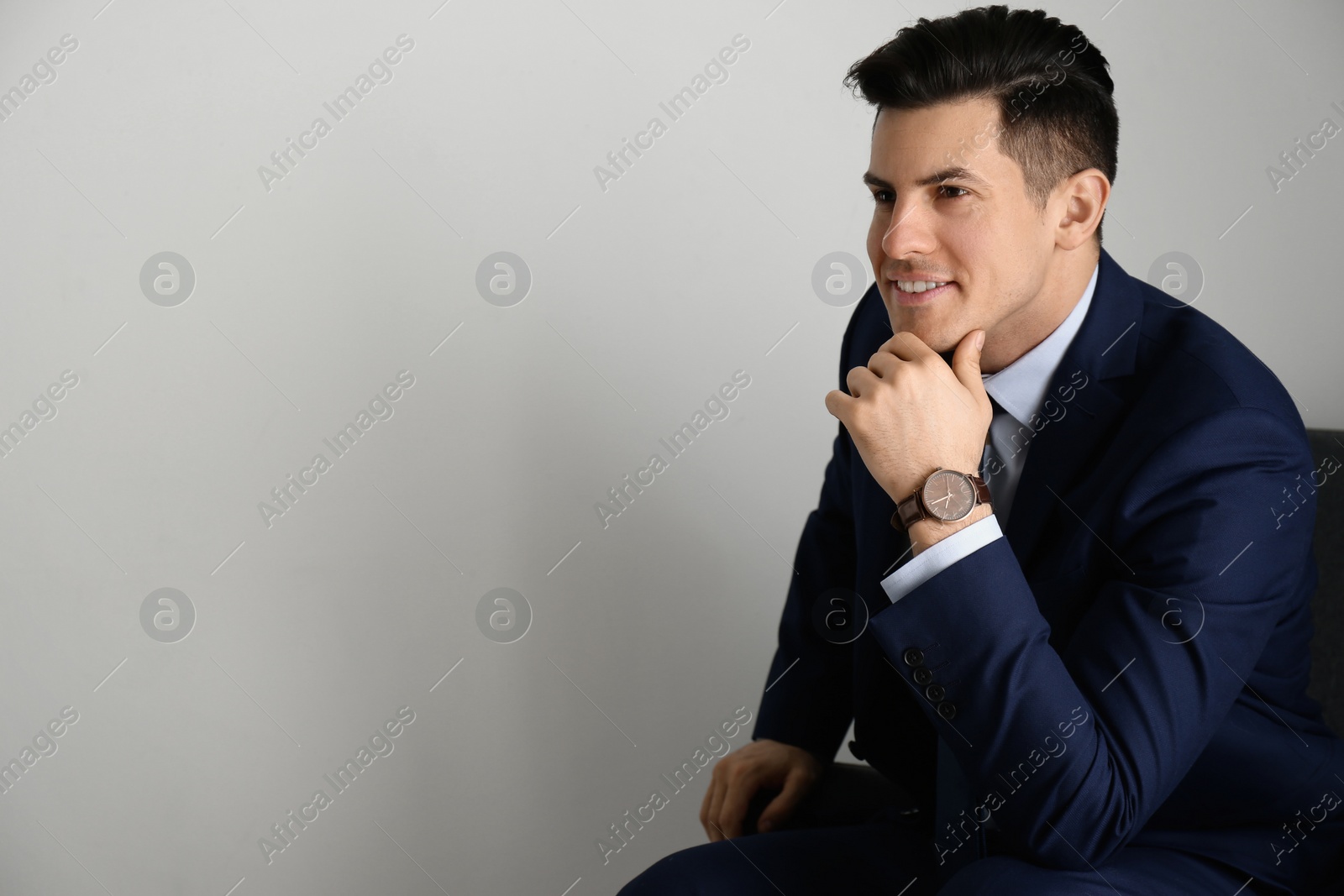 Photo of Businessman with luxury wrist watch on grey background. Space for text