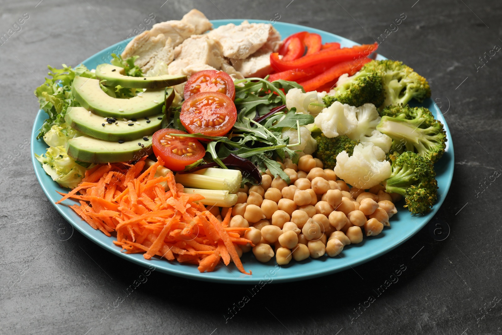 Photo of Balanced diet and healthy foods. Plate with different delicious products on black table