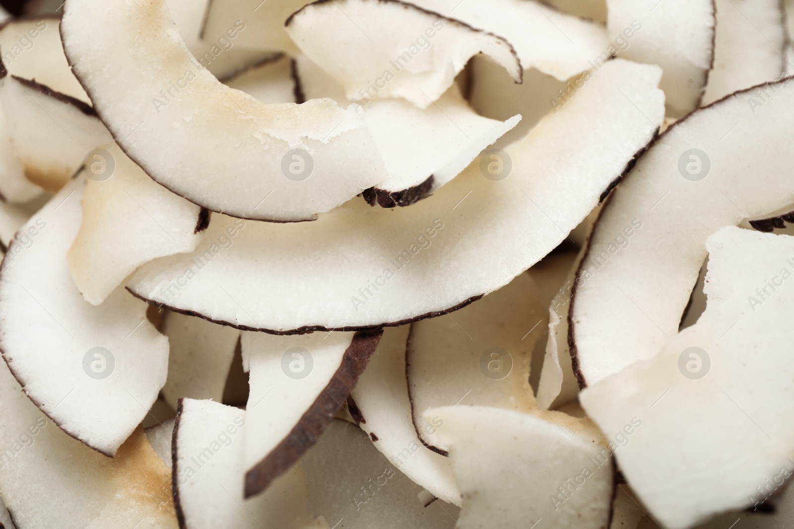 Photo of Fresh delicious coconut chips as background, closeup