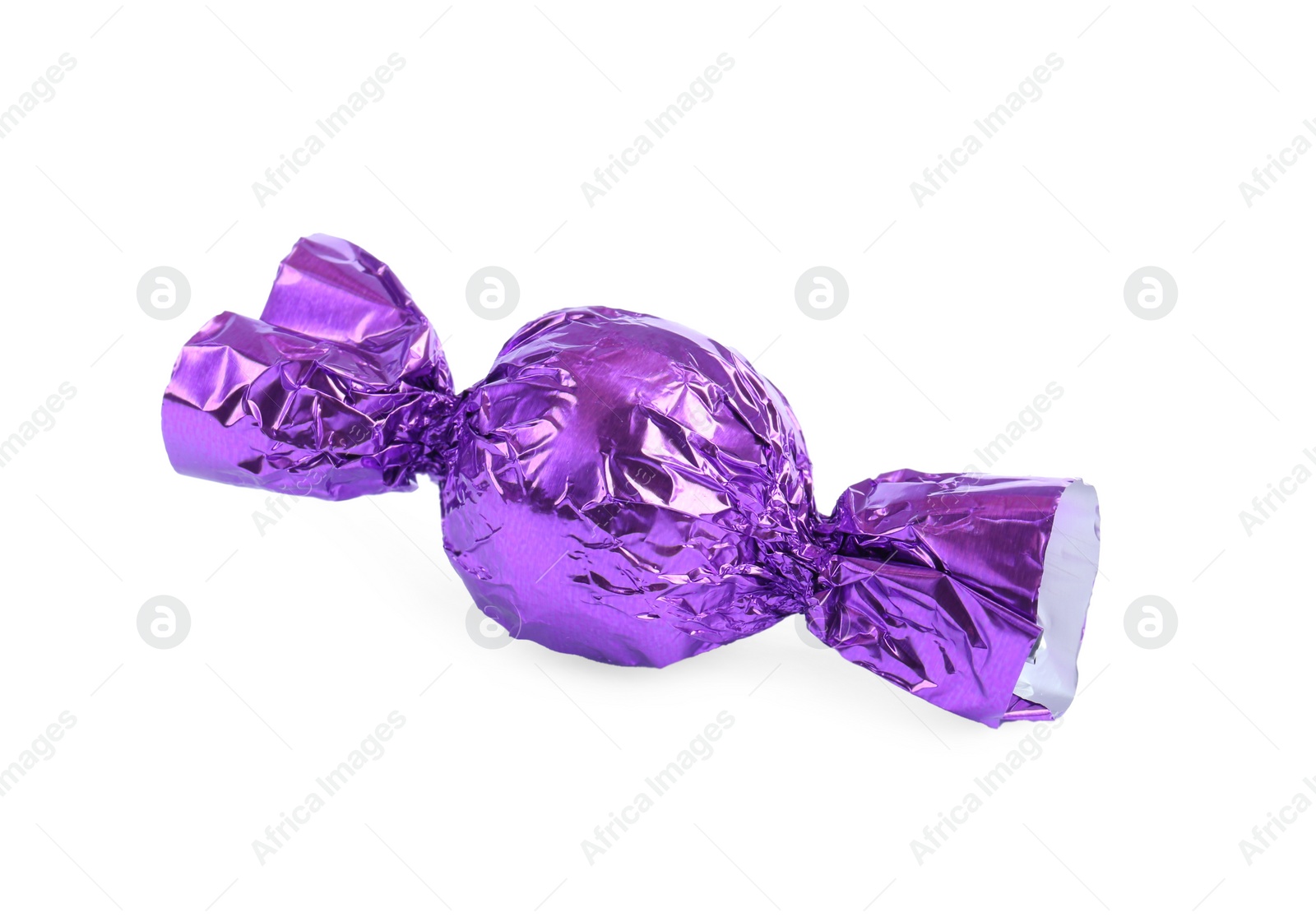 Photo of Tasty candy in purple wrapper isolated on white