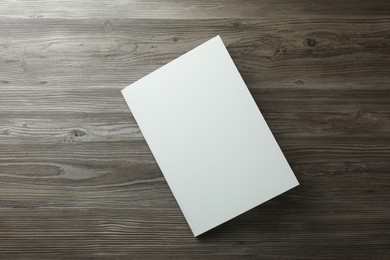 Photo of Blank paper brochure on wooden table, top view. Mockup for design