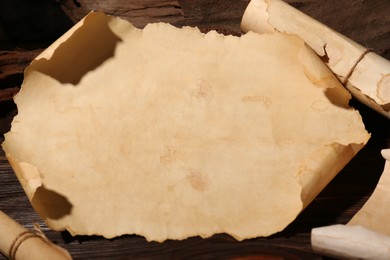 Photo of Sheets of old parchment paper on wooden table