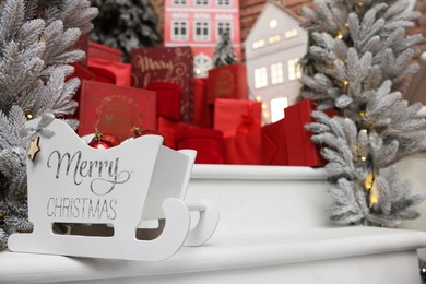 Photo of Stylish Christmas decor and gift boxes on white stairs indoors, space for text