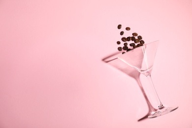 Flat lay composition with glass, coffee beans and space for text on color background. Alcohol cocktail recipe - Espresso Martini