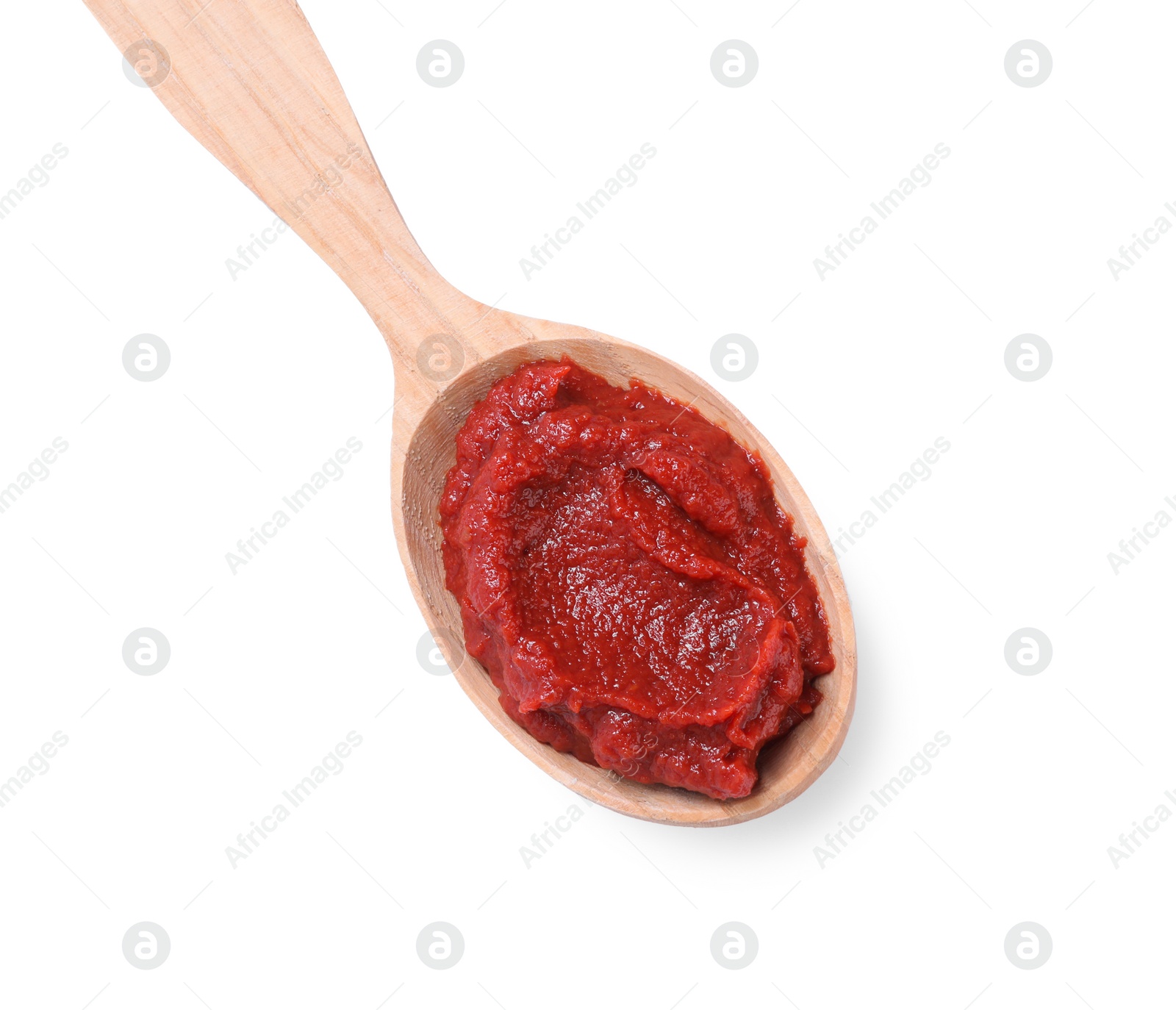 Photo of Wooden spoon of tasty tomato paste isolated on white, top view