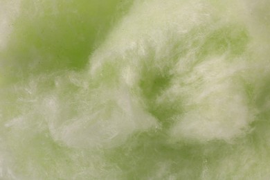 Green cotton candy as background, closeup view