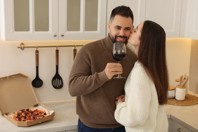 Photo of Happy young couple spending time together in kitchen