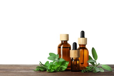 Photo of Bottles of essential oil and fresh herbs on wooden table against white background
