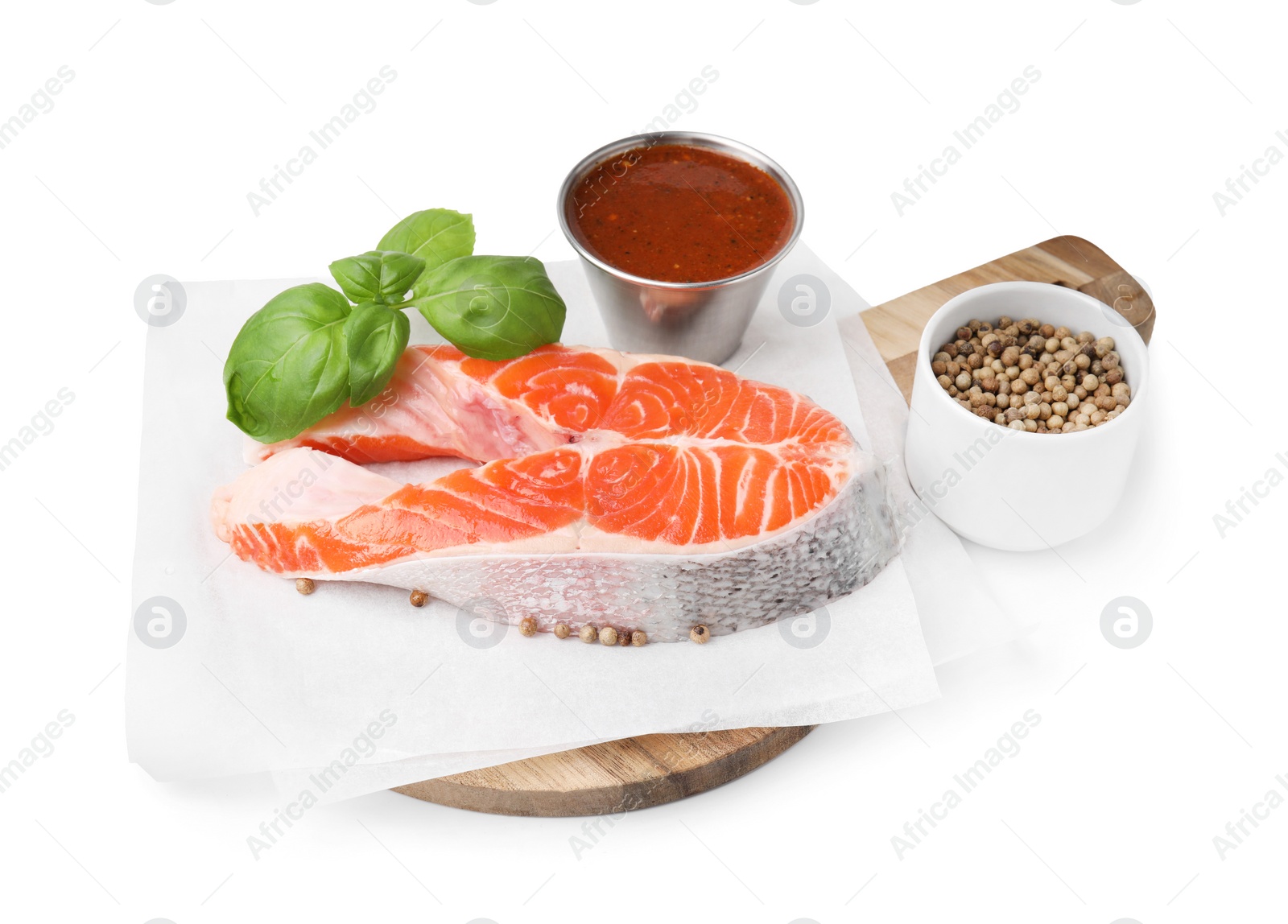 Photo of Fresh fish, basil, peppercorns and marinade isolated on white