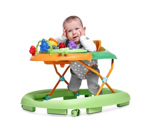 Portrait of cute little boy in baby walker on white background