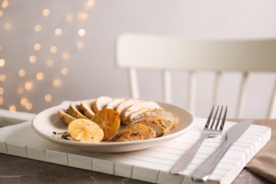 Tasty lemon chicken served on brown marble table