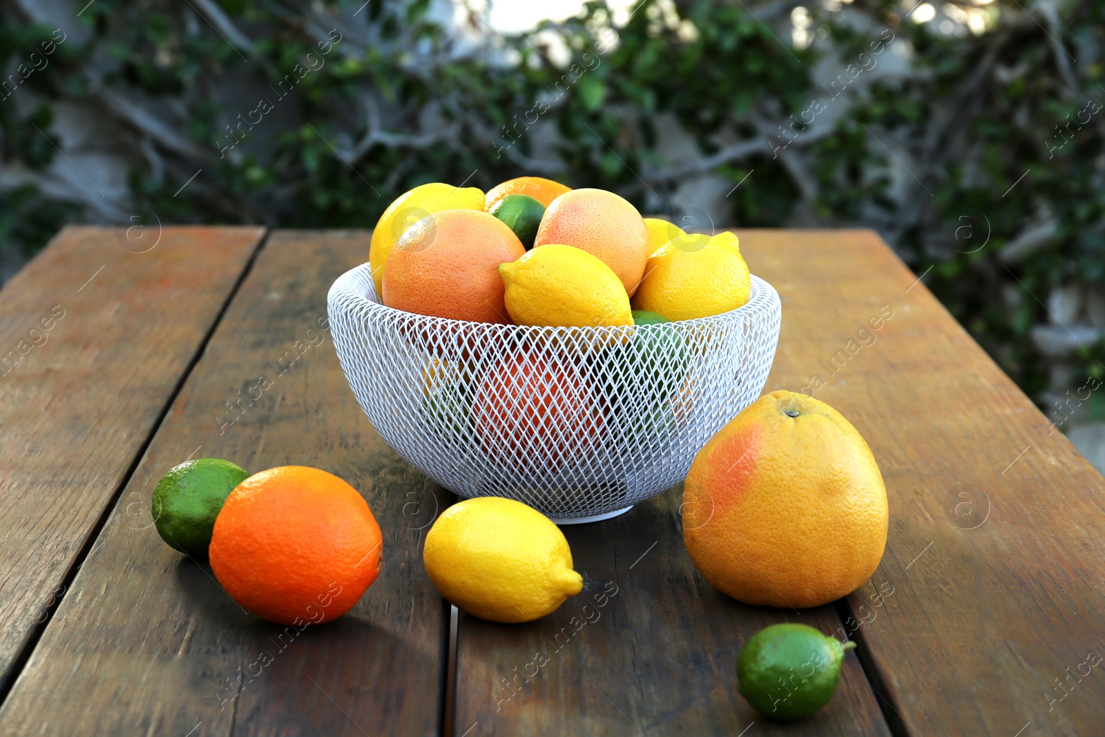 Photo of Many different citrus fruits on wooden table