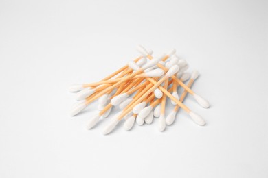 Photo of Pile of clean cotton buds isolated on white