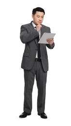 Businessman in suit using tablet on white background