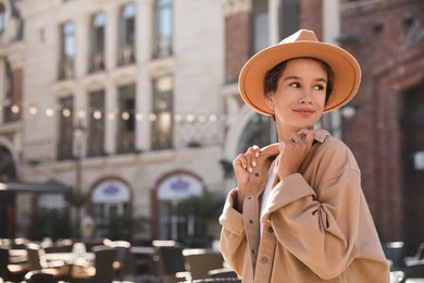 Photo of Portrait of happy young woman on city street