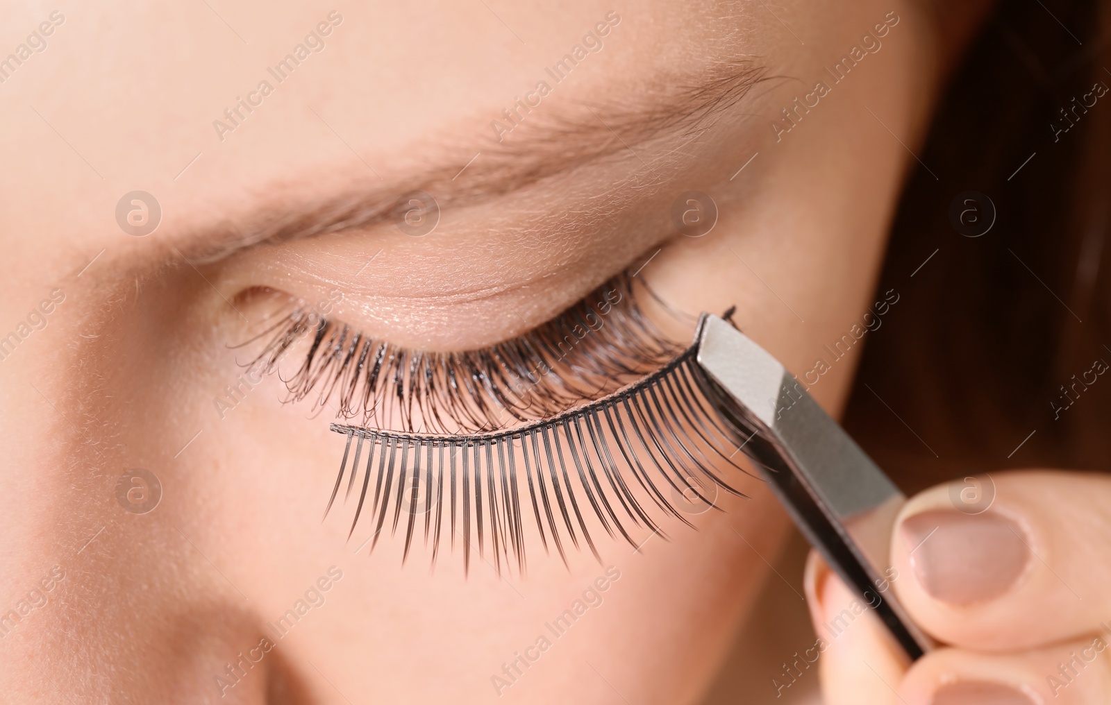 Photo of Attractive young woman with false eyelashes, closeup