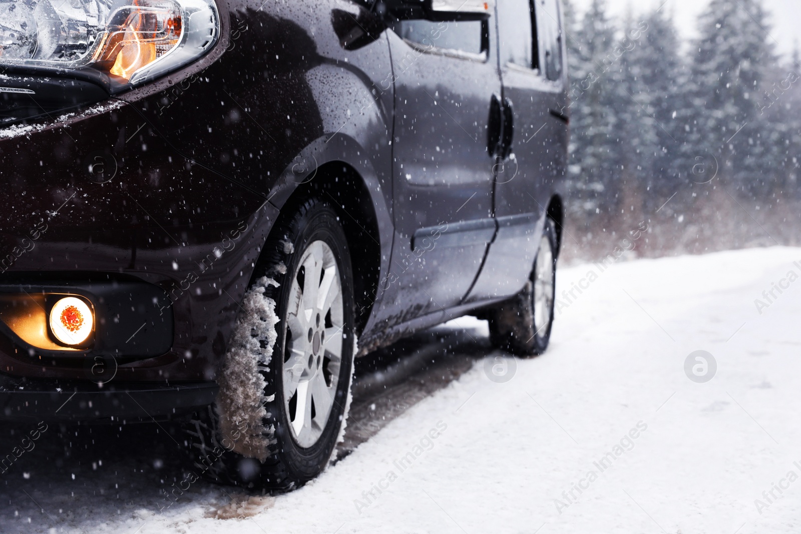 Photo of Country road with car on snowy winter day