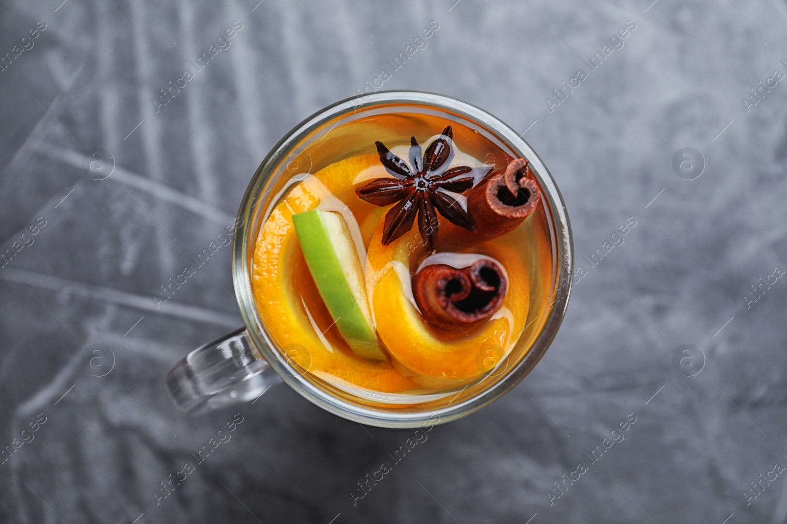 Photo of Aromatic white mulled wine on grey table, top view