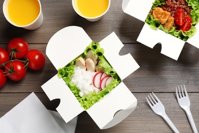 Photo of Flat lay composition with healthy takeaway food on wooden table