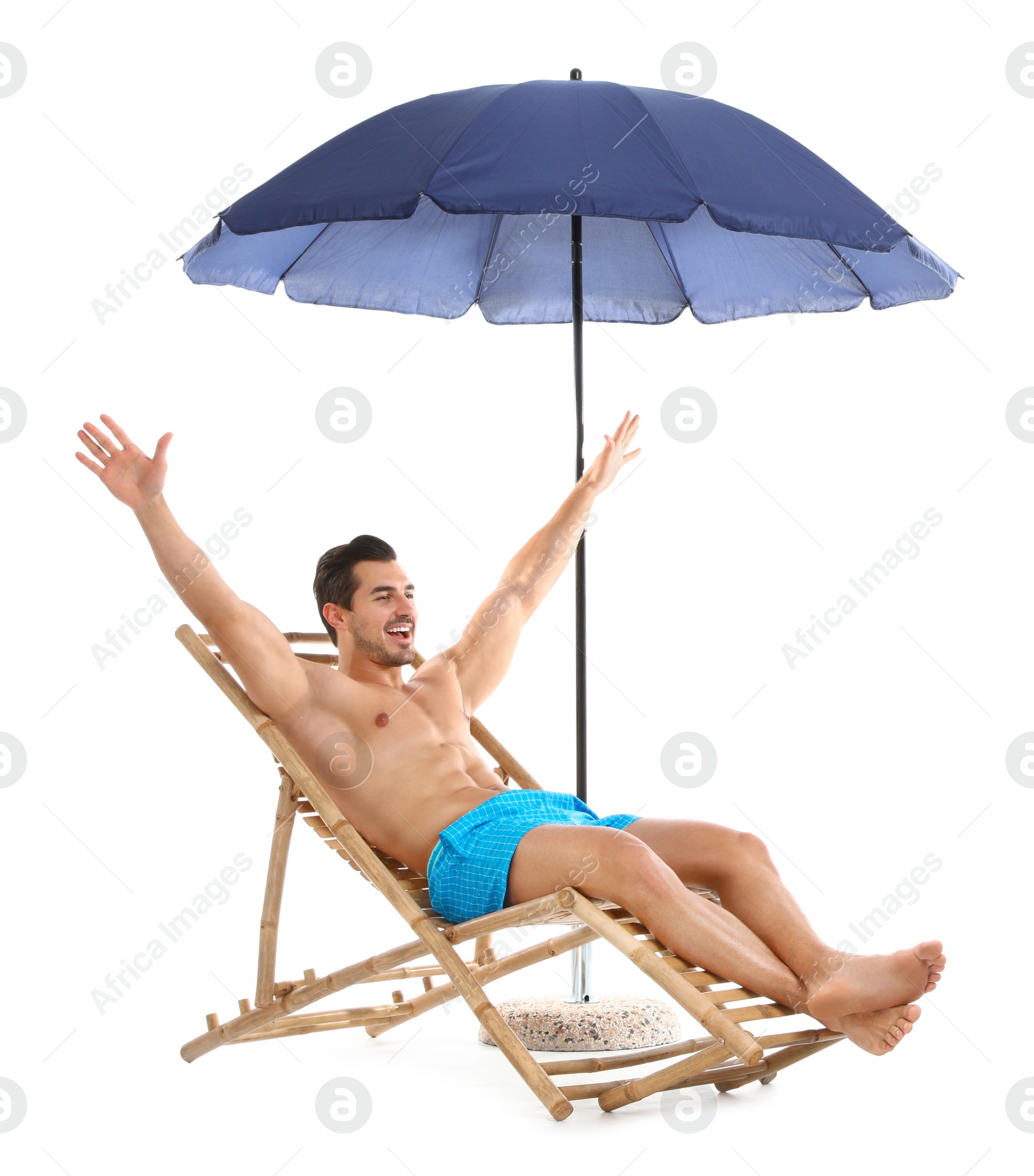 Photo of Young man on sun lounger under umbrella against white background. Beach accessories