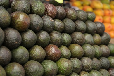 Photo of Pile of delicious fresh ripe avocados at market