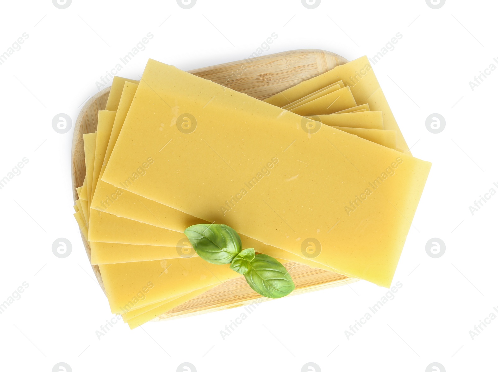 Photo of Uncooked lasagna sheets and basil isolated on white, top view