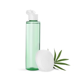 Photo of Bottle of micellar cleansing water, cotton pads and green twig on white background