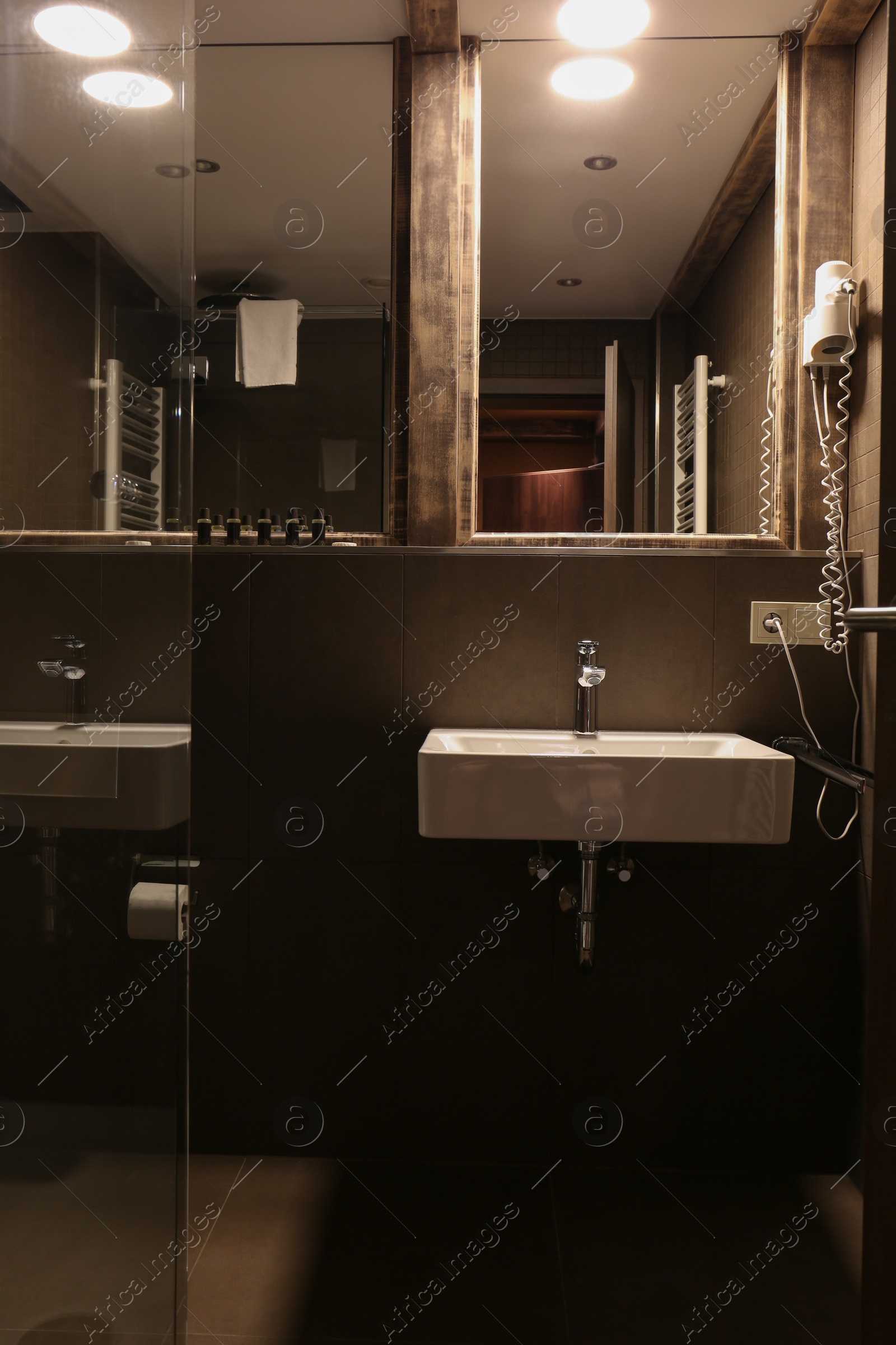 Photo of Stylish bathroom with sink in luxury hotel. Interior design
