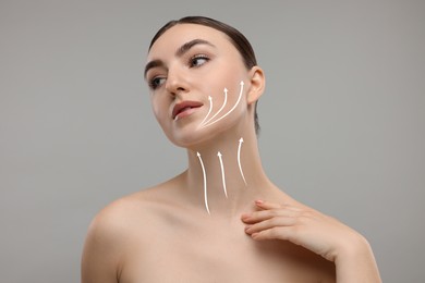 Image of Woman with perfect skin after cosmetic treatment on grey background. Lifting arrows on her neck and face