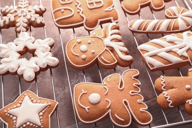 Photo of Delicious Christmas cookies on cooling rack, closeup