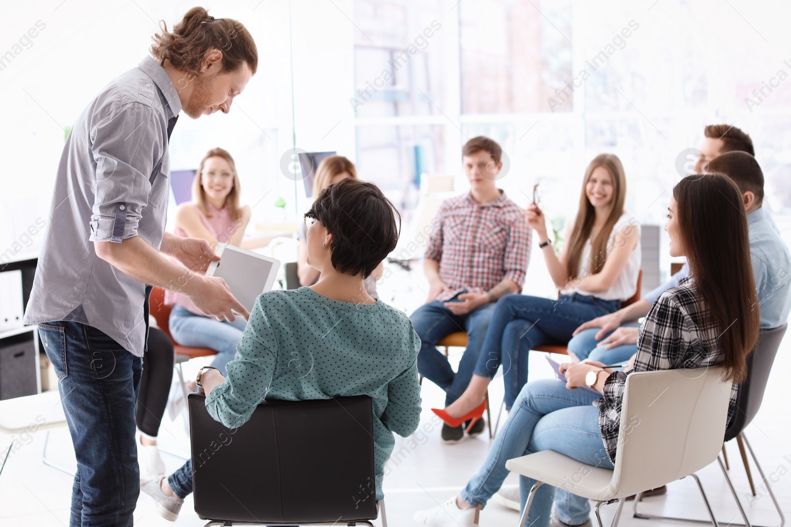 Photo of Male business trainer giving lecture in office