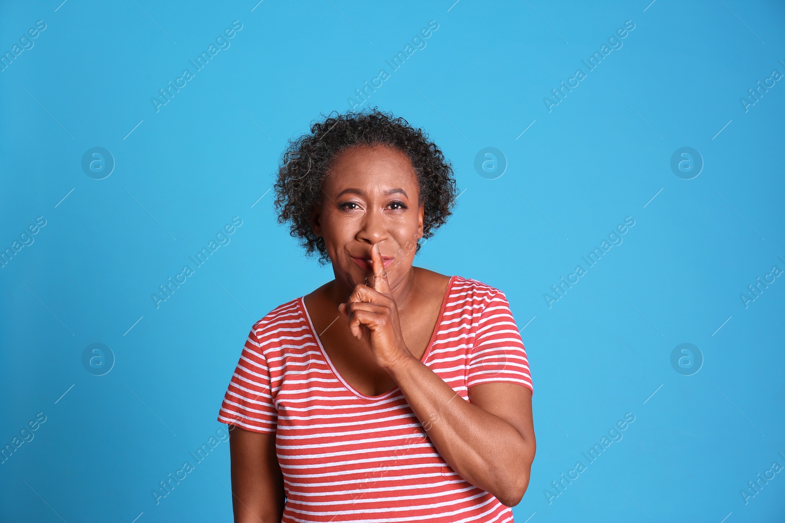 Photo of Portrait of African-American woman on light blue background