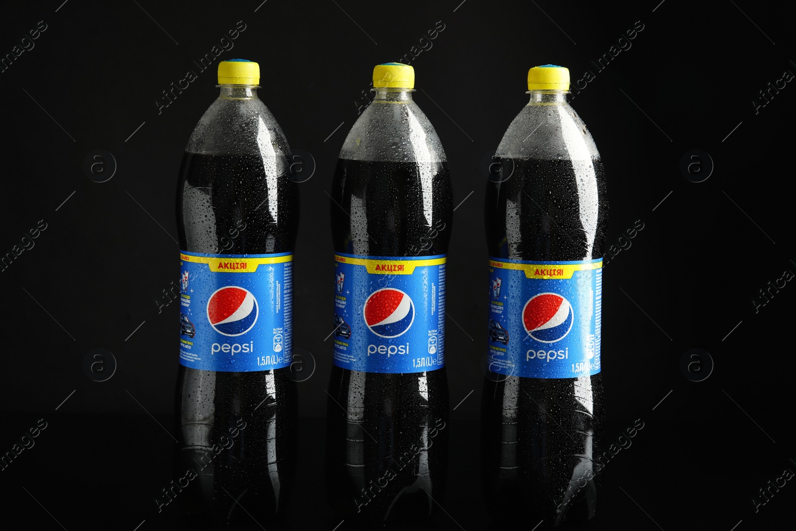 Photo of MYKOLAIV, UKRAINE - FEBRUARY 9, 2021: Bottles of Pepsi on black background