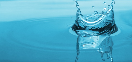 Photo of Splash of blue water with drop, closeup