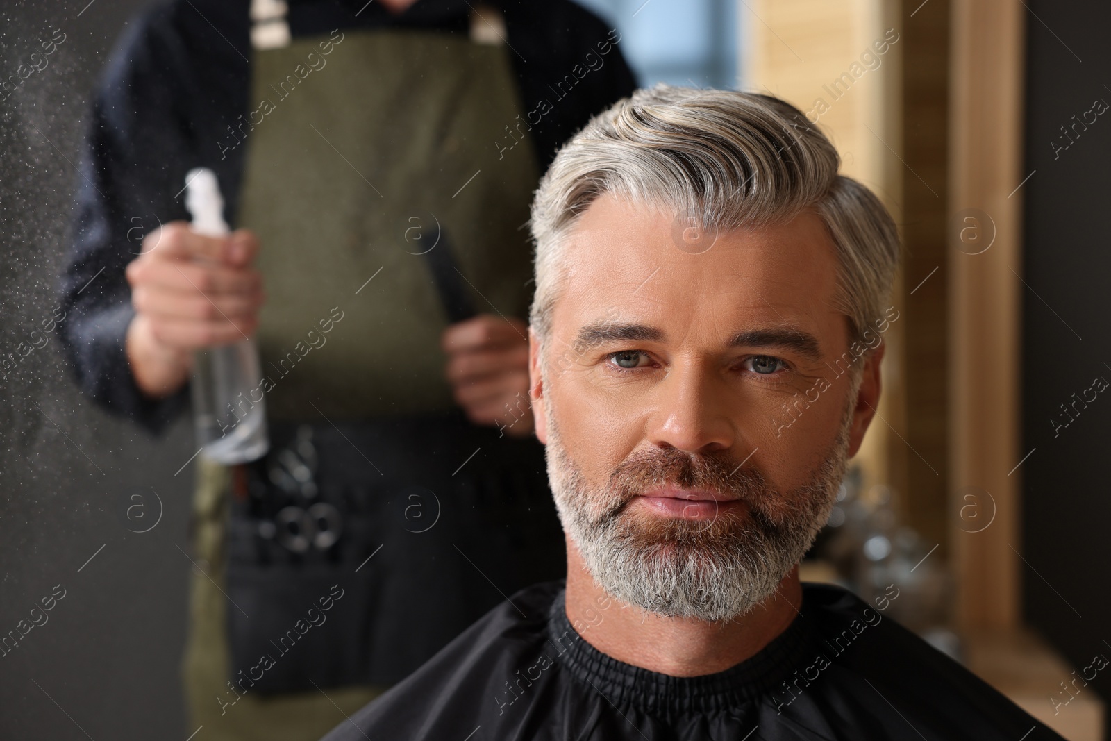 Photo of Hair styling. Professional hairdresser working with client in barbershop, closeup