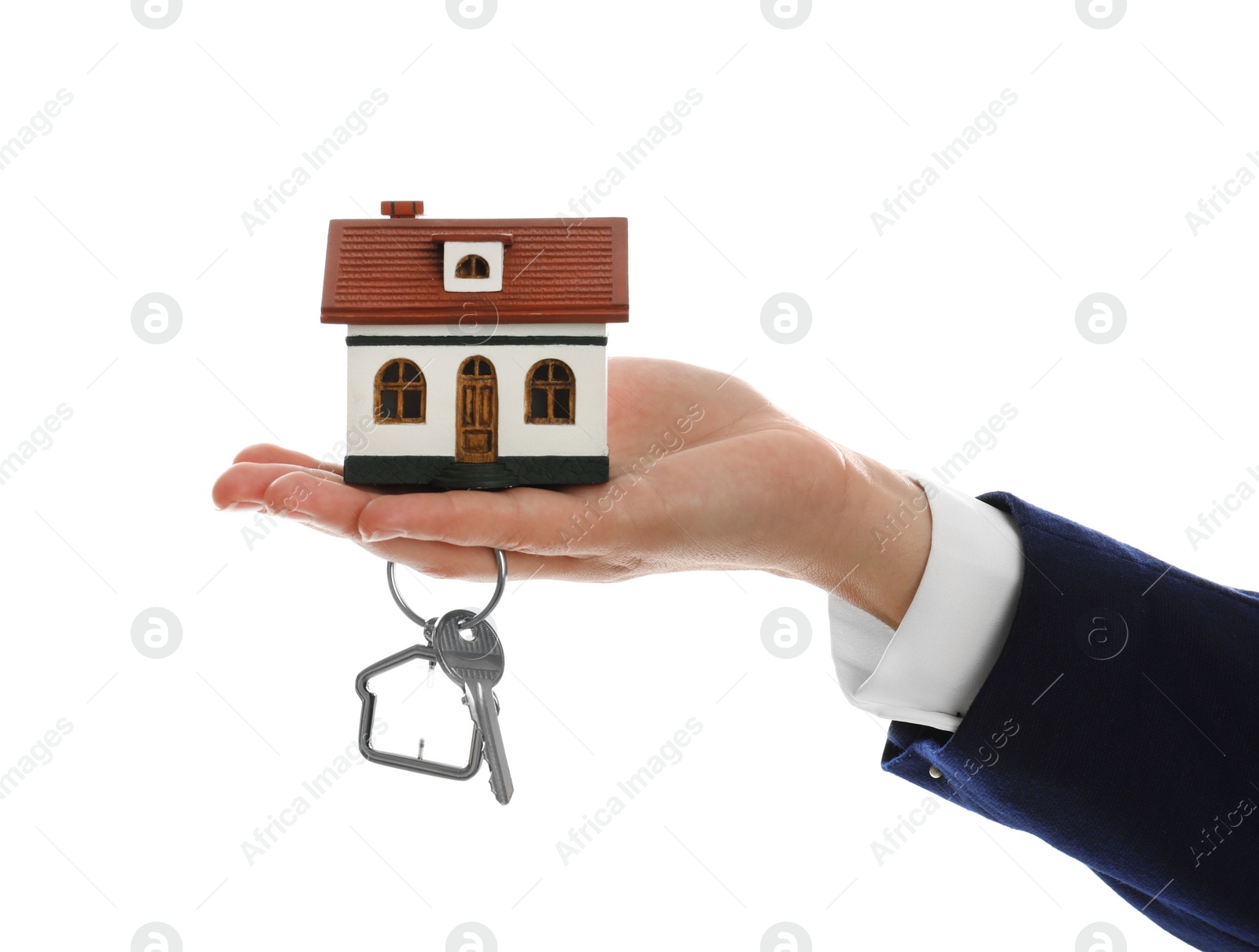 Photo of Real estate agent holding house model and key on white background, closeup