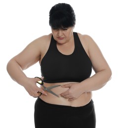 Photo of Obese woman with scissors on white background. Weight loss surgery