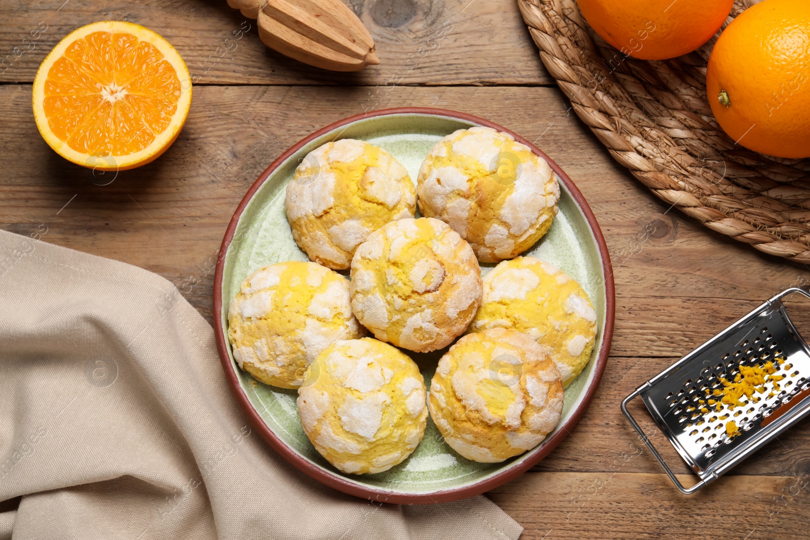 Photo of Plate with tasty homemade cookies on wooden table, flat lay