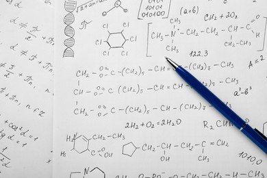 Photo of Sheets of paper with different chemical formulas and pen, top view